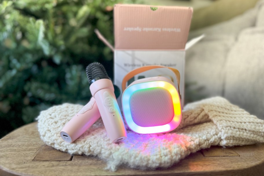 two mini pink microphones and mini pink karaoke machine