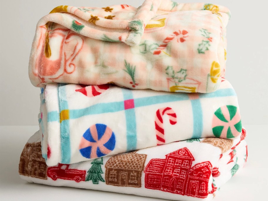 three plush holiday blankets