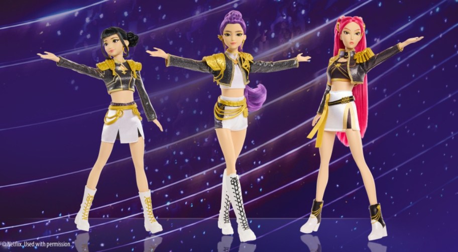 3 Kpop dolls on a blue background