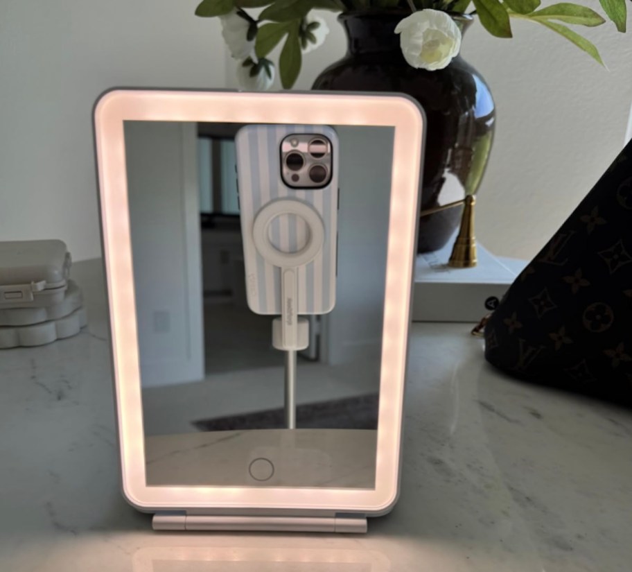 rectangle mirror on countertop with phone in reflection