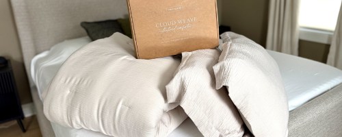 cream comforter and pillows on bed with box