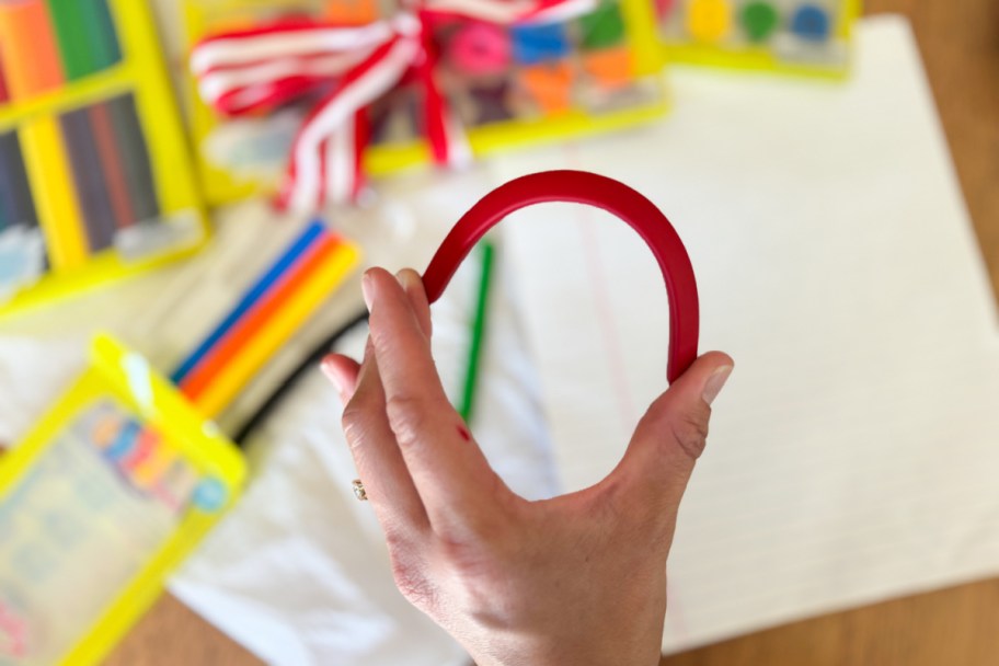 hand bending red crayon