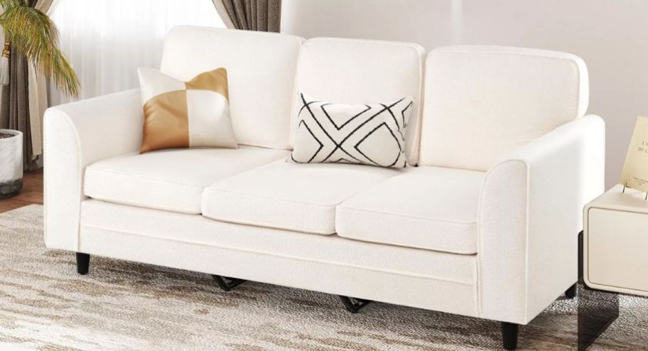 macys beige couch with throw pillows on there