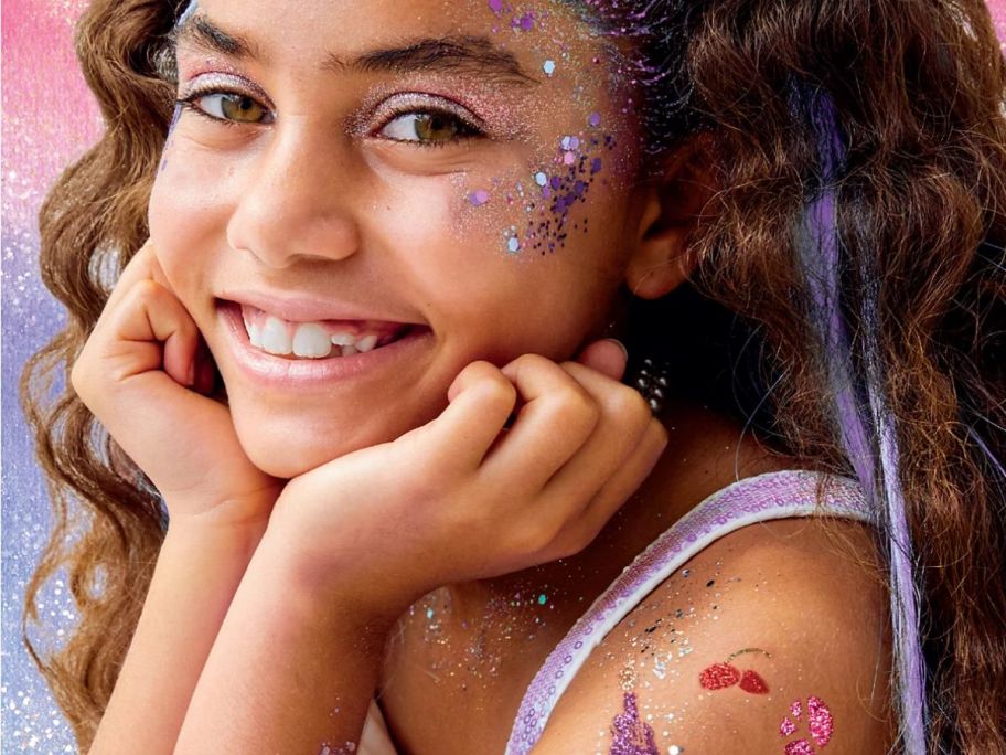 little girl wearing makeup kit 
