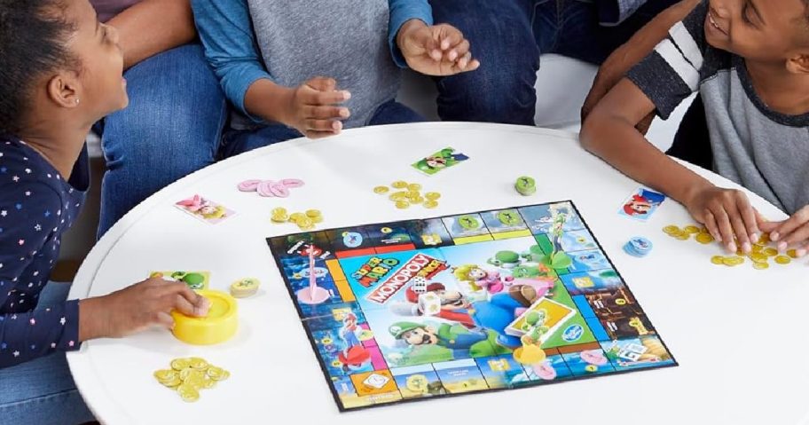 A family playing a Monopoly Junior Mario game.