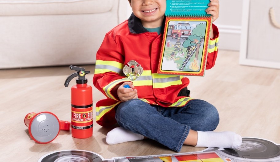 a little boy in a fireman costume