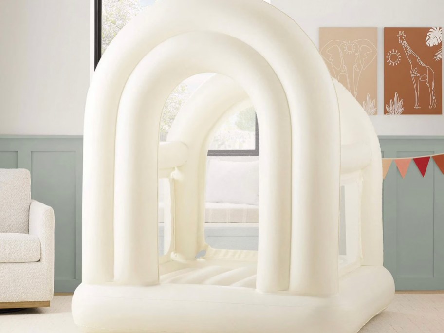 cream inflatable bounce house in room