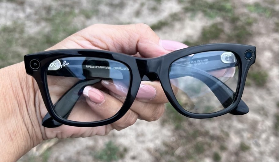 hand holding a pair of meta smart glasses