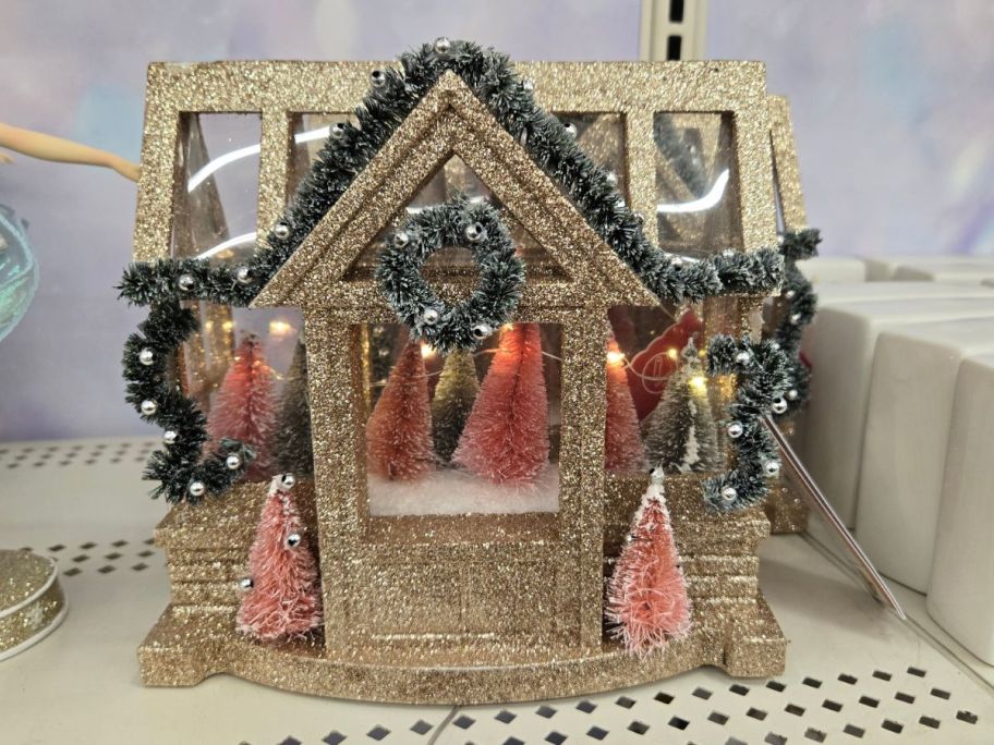 Gold Glitter House LED Tabletop Décor on shelf in store