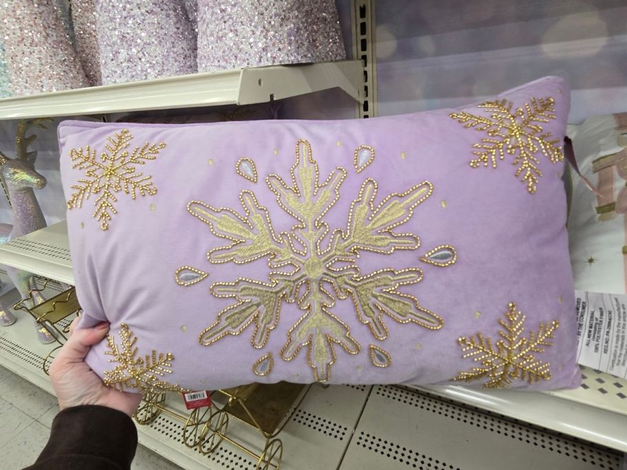 Snowflake Lumbar Throw Pillow in hand in store