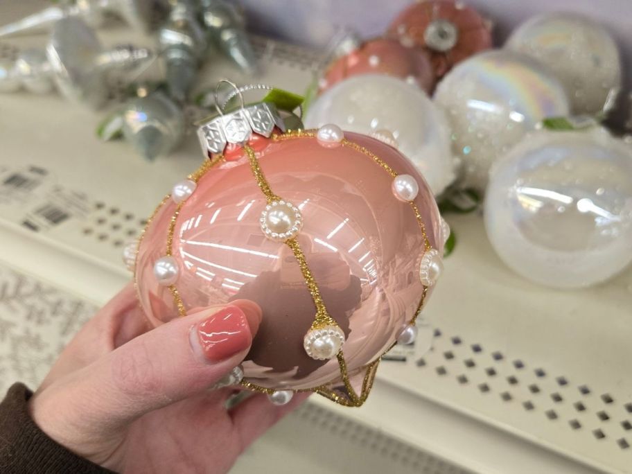 Beaded Glass Onion Ornament in hand in store