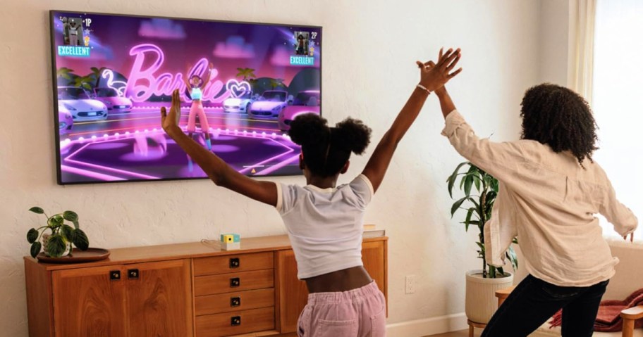 woman and girl playing with the nex playground in front of a TV