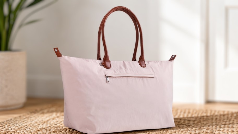 a large weekender bag sitting on the floor