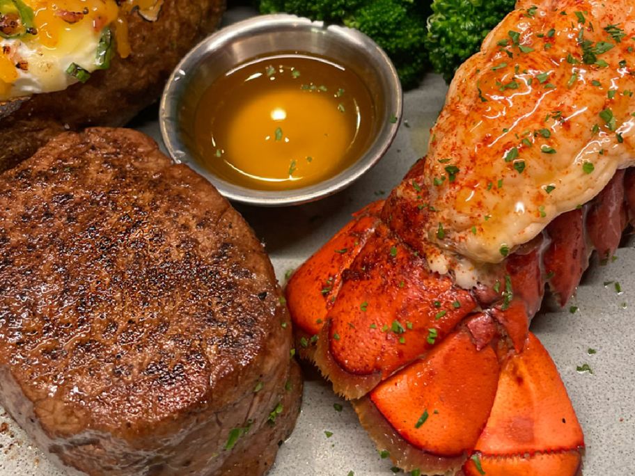 steak and lobster tail on a place with melted butter