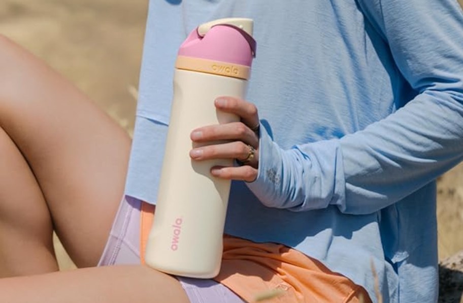 hand holding an owala free sip water bottle