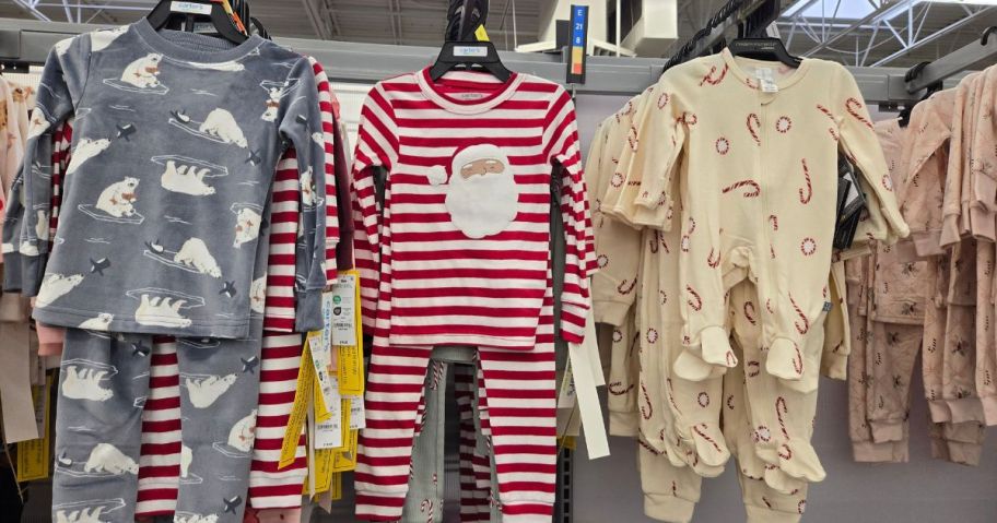three sets of toddler pajamas hanging in store