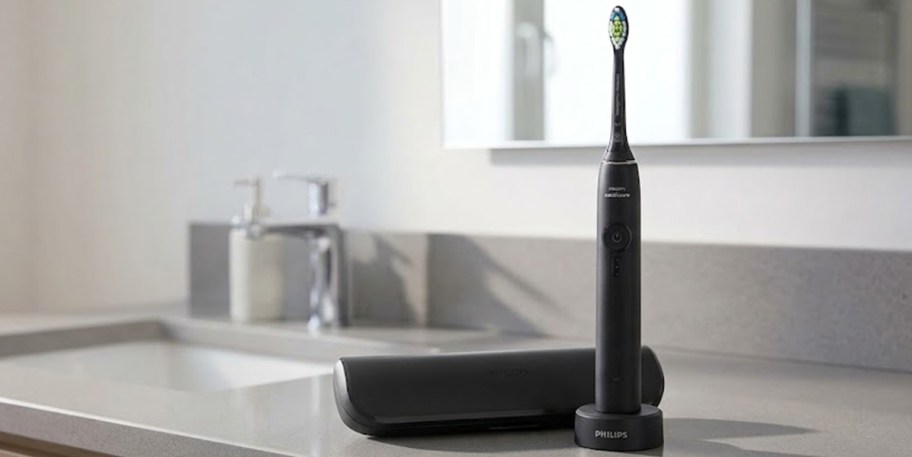 black electric toothbrush and case on countertop 
