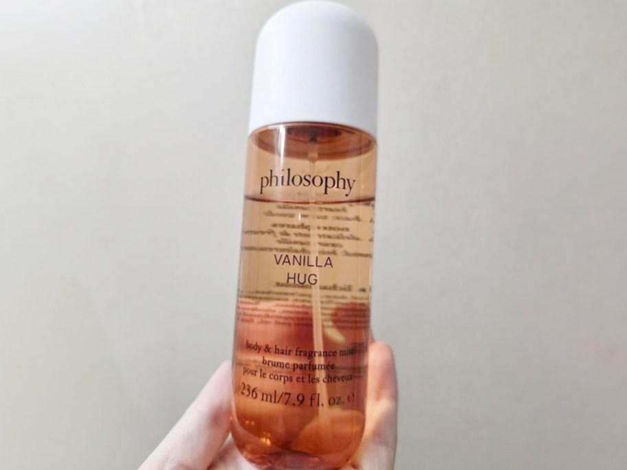 hand holding philosophy fragrance mist