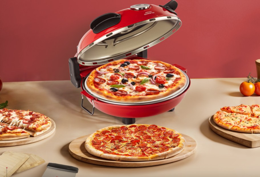 A pizza oven with a pizza inside of it.
