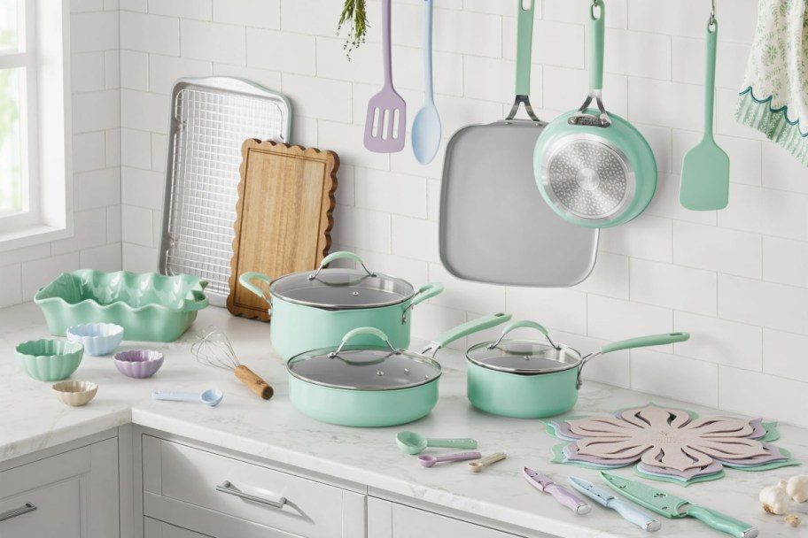 Teal cookware and bakeware pieces on a kitchen counter