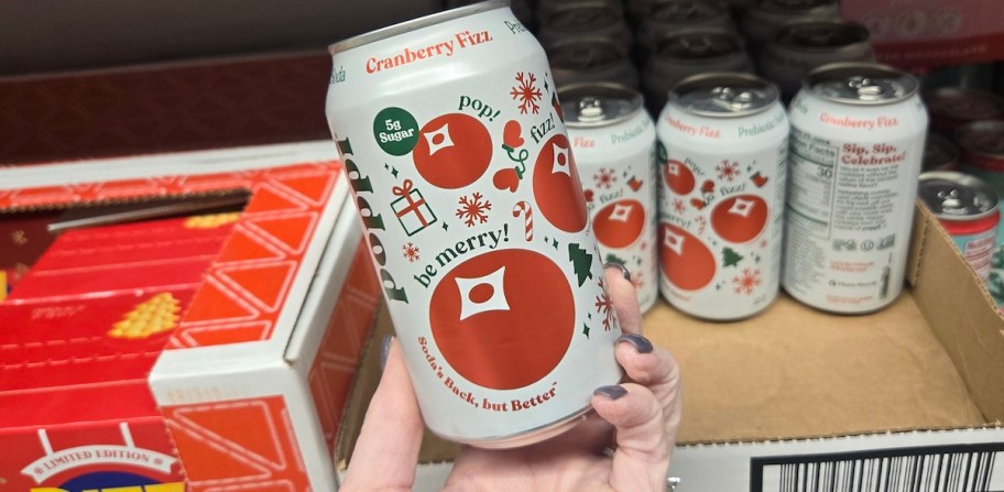 hand holding a can of poppi