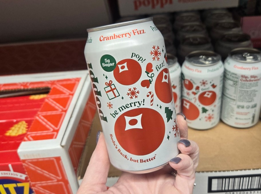 hand holding poppi can