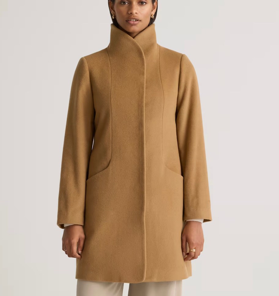 woman wearing camel colored jacket