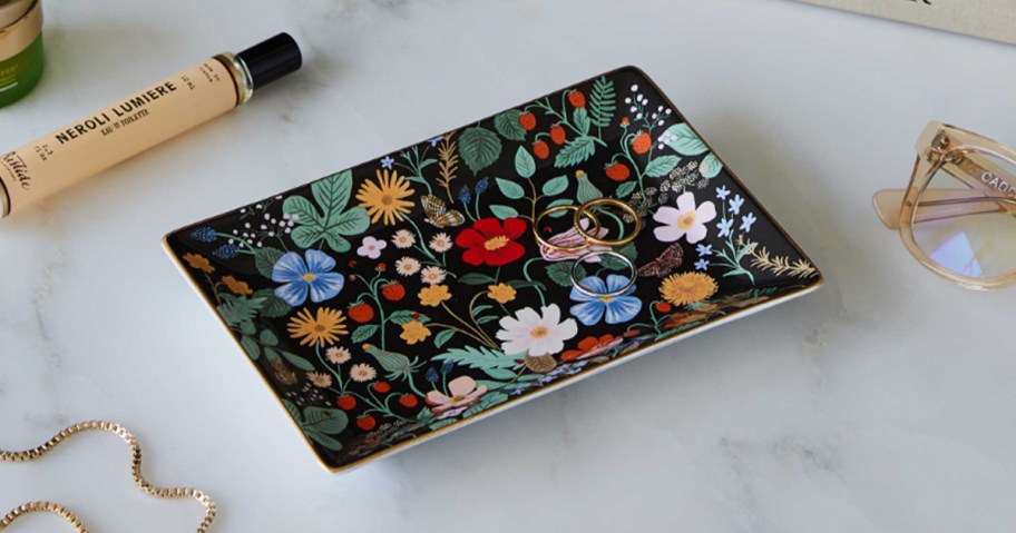 black floral trinket tray with rings on top