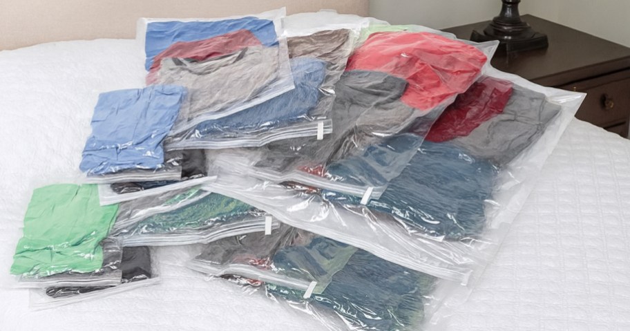 samsonite compression bags on a bed