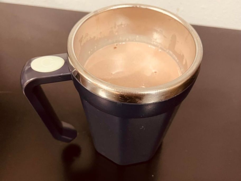 self stirring mug with coffee in it