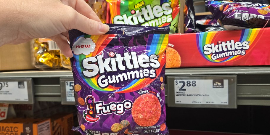hand holding bag of skittles fuego gummies