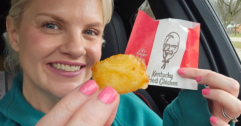 smiling woman holding KFC Cheese Curd in car