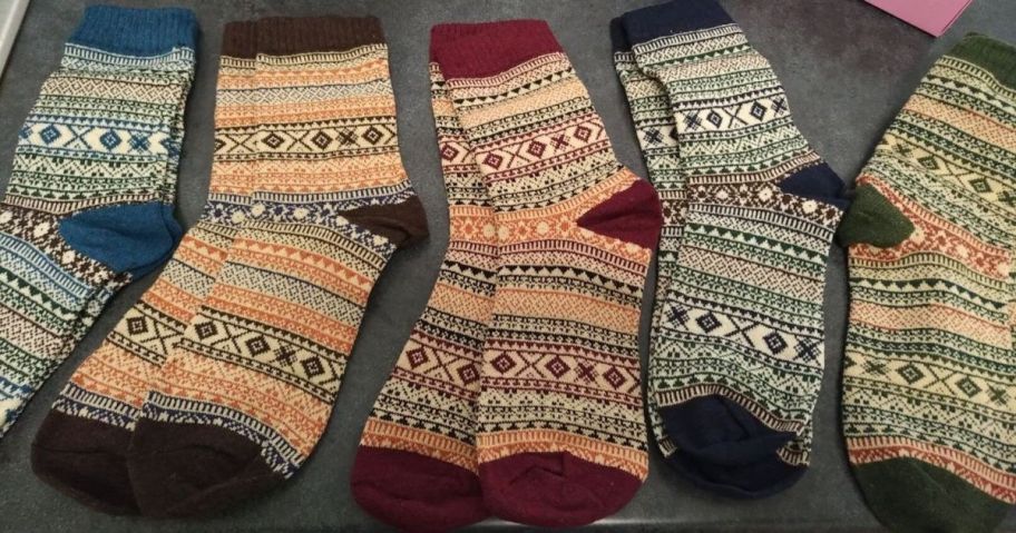 five women's wool socks on table