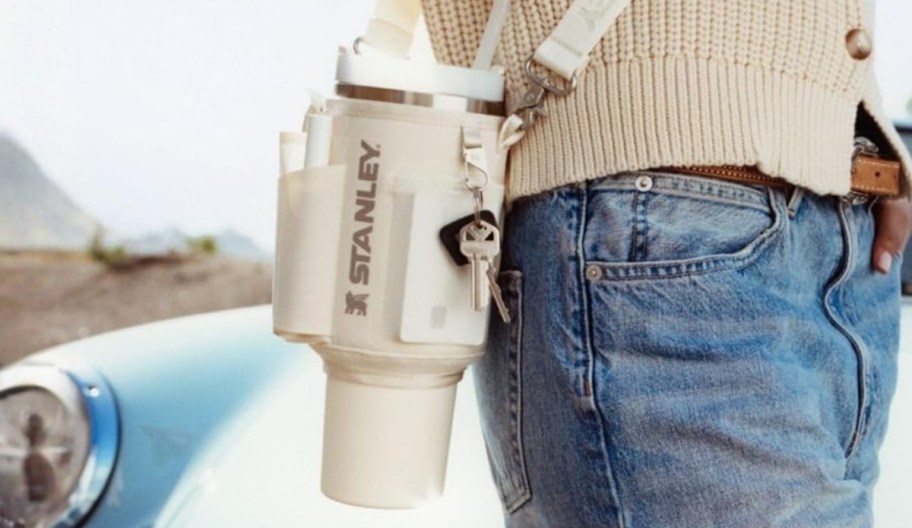 a man carrying a stanley carry all with a tumbler