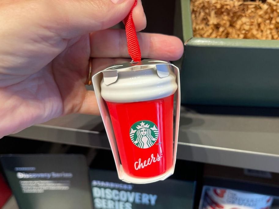 starbucks Holiday Ornament in hand in store