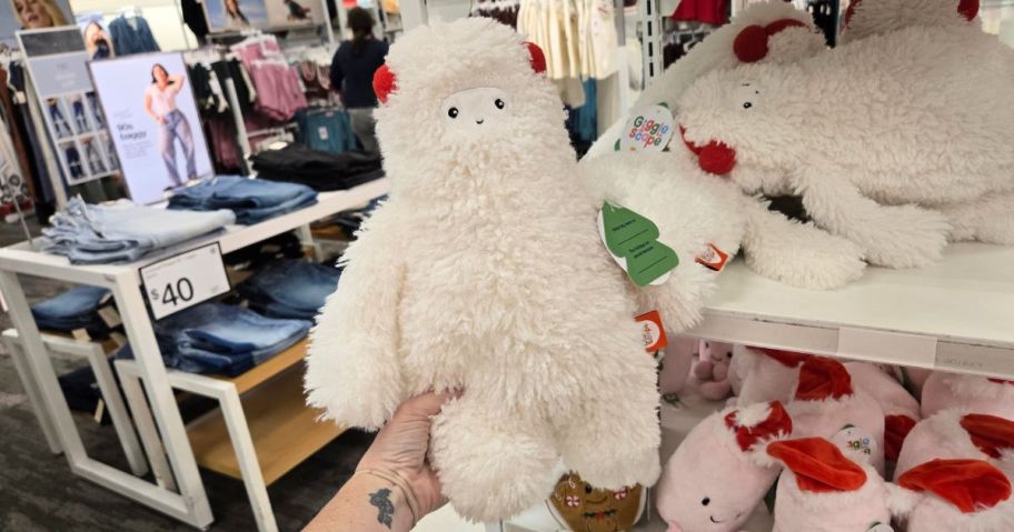 hand holding Yeti Plush wearing red earmuffs