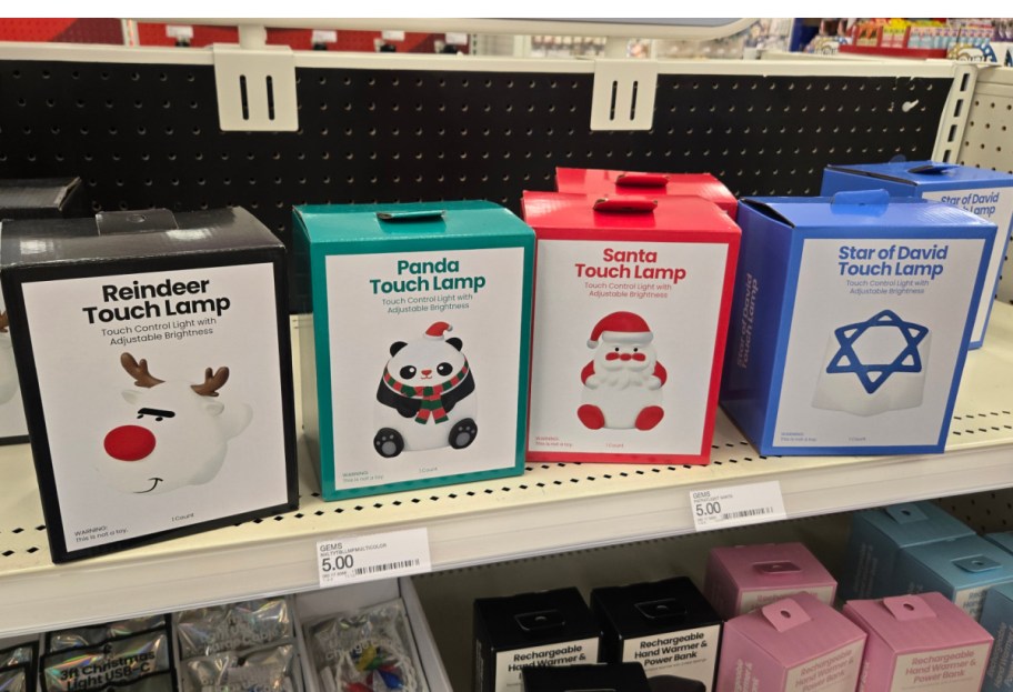 Four boxes containing holiday themed touch lamps.