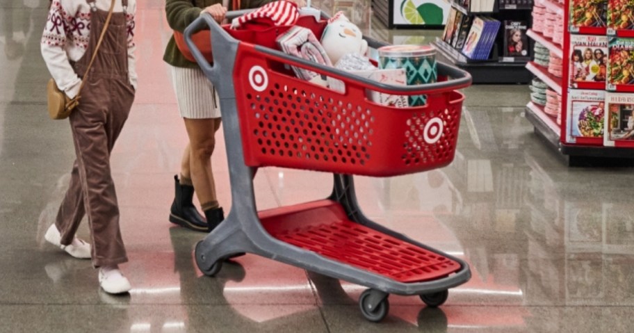 people pushing a Target shopping cart in store