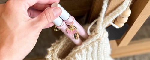 tarte Maracuja Juicy Lip tubes being placed in a white knit stocking