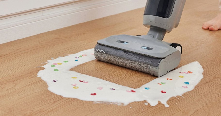 person using a tineco vac to clean milk and cereal