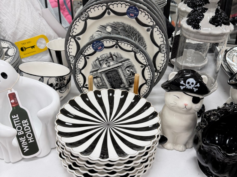 A collection of glass tumblers with bamboo lids and glass straws, featuring colorful Halloween designs of ghosts, cats, and pumpkins.