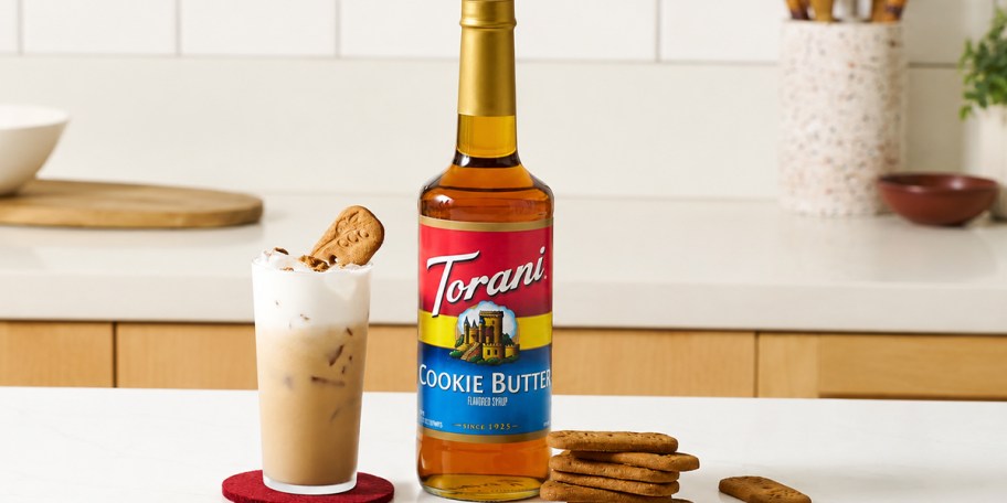cookie butter syrup on table with drink on counter 