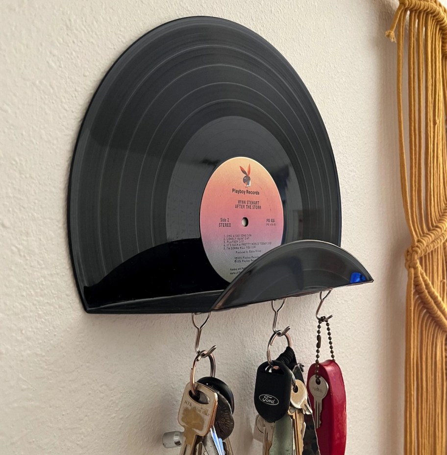 Vinyl record shelf with keys hanging from hooks on bottom