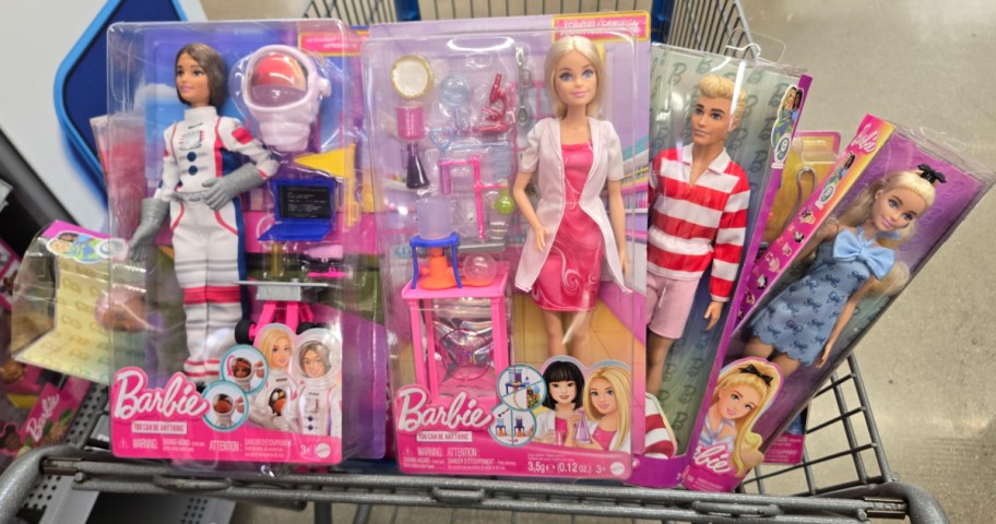 A variety of Barbies in a cart at Walmart.