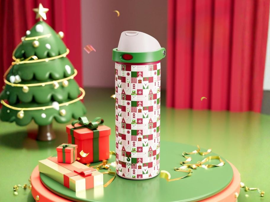 christmas water bottle amongst presents and tree
