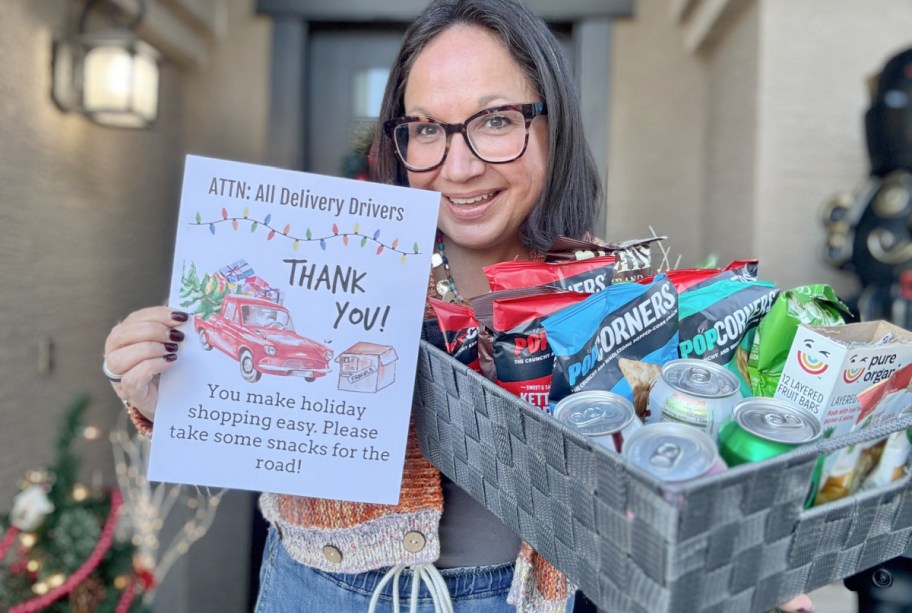 woman holding a delivery person's snack basket with snacks