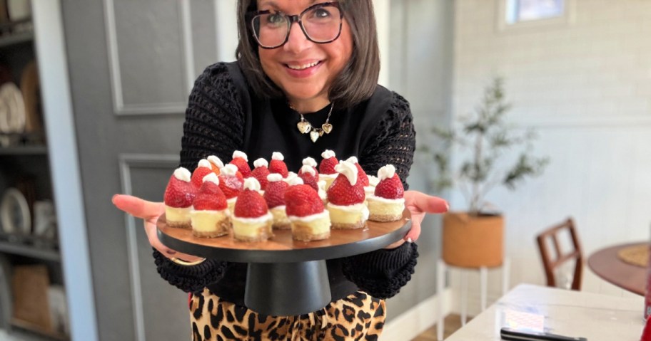 woman holding a plate of santa hats