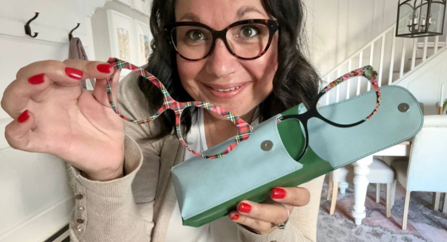 woman holding and wearing Glasses