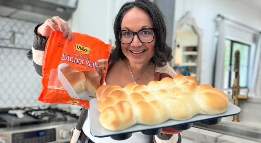 woman holding dinner rolls in a muffin pan