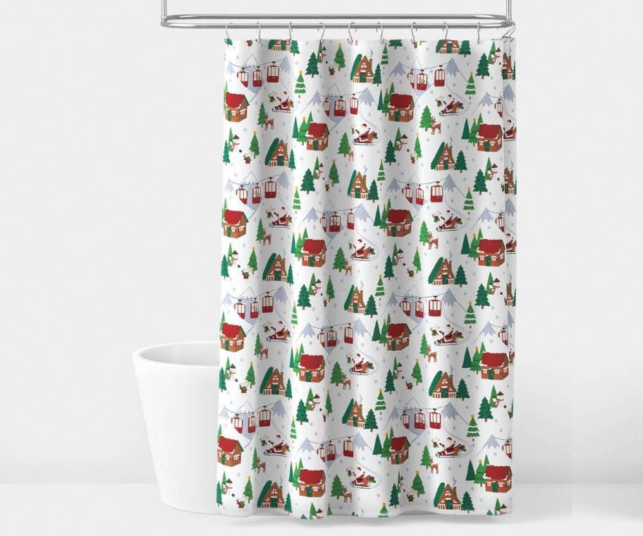 holiday shower curtain hung in front of bath tub